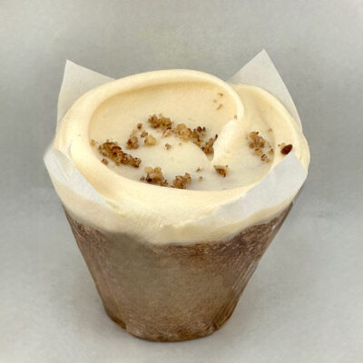 Moist carrot cupcake with an even balance of spices and crunchy pecans (no raisins here) and cream cheese frosting.