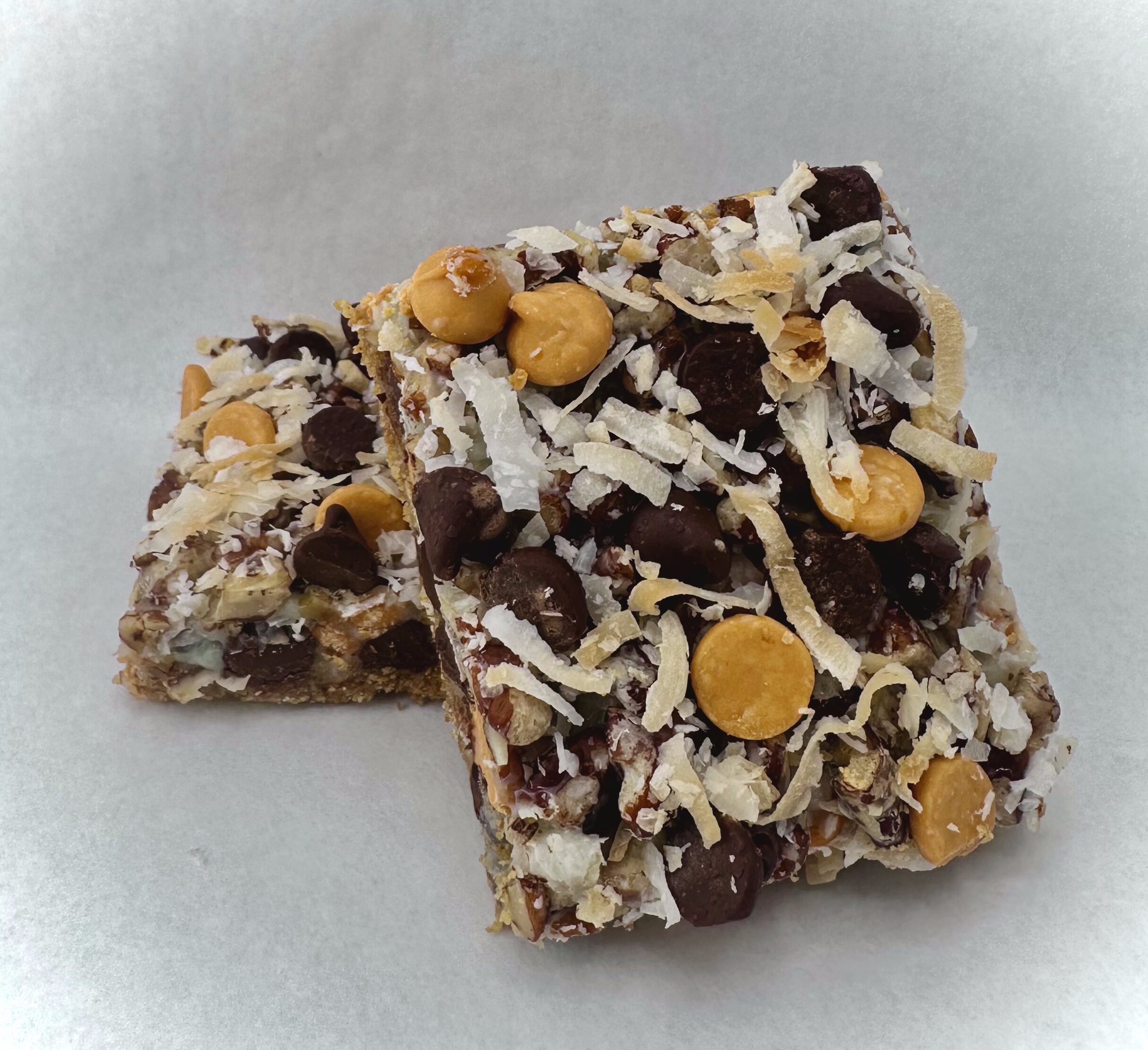 Soccer Mom dessert bar with a graham cracker base layered with coconut, pecans, semi-sweet chocolate chips, and butterscotch.